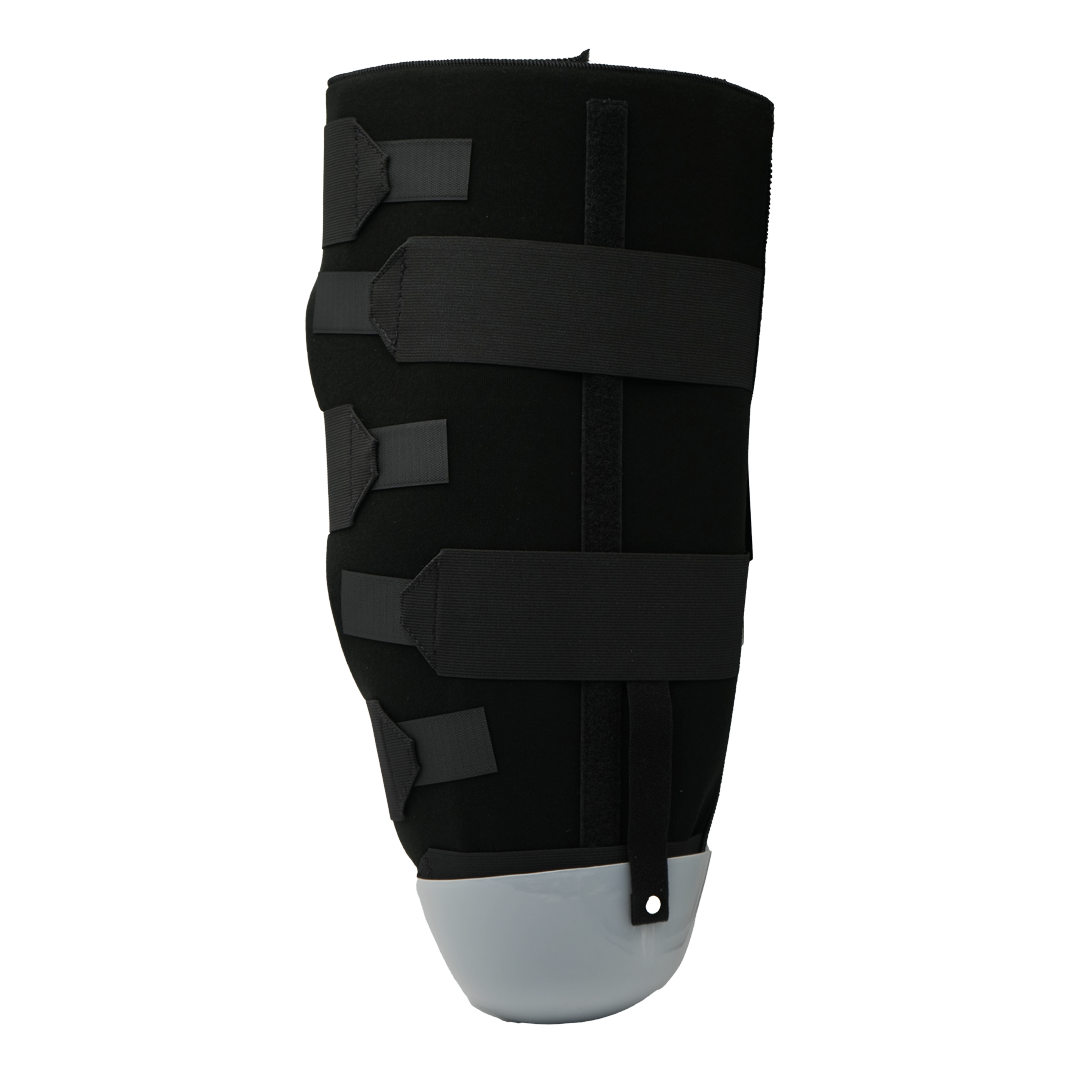 Black below knee amputee rigid dressing protector with adjustable hook-and-loop straps and gray protective cap.