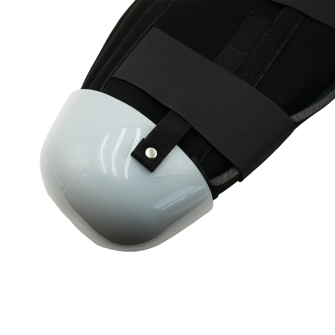 White rigid protective cap with black adjustable straps for below knee amputee dressing.