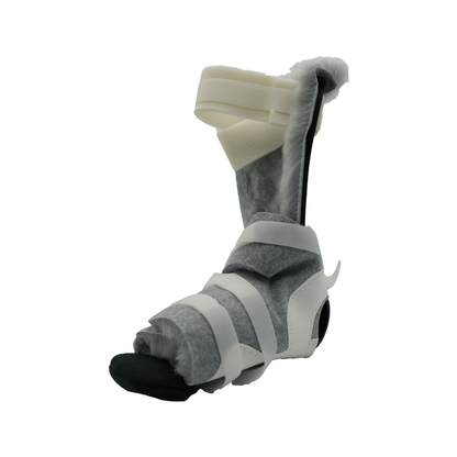Gray and black medical foot brace with white adjustable straps and rigid ankle support.