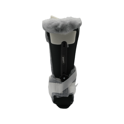 Black orthopedic Multi Podus boot with white straps and soft gray fleece lining.