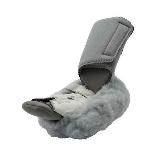 Gray orthopedic foot brace with fluffy lining and adjustable straps for secure fit.
