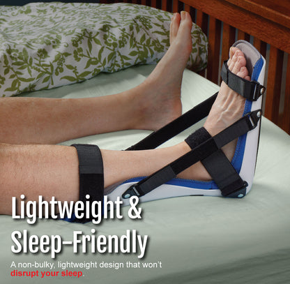 Black and blue plantar fasciitis night splint secured with adjustable straps on foot resting on a bed.