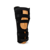 Black adjustable knee immobilizer brace with multiple straps and open patella design on beige mannequin leg.