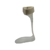 Lightweight beige RCAI leaf spring orthosis AFO with cushioned ankle strap for foot drop support.
