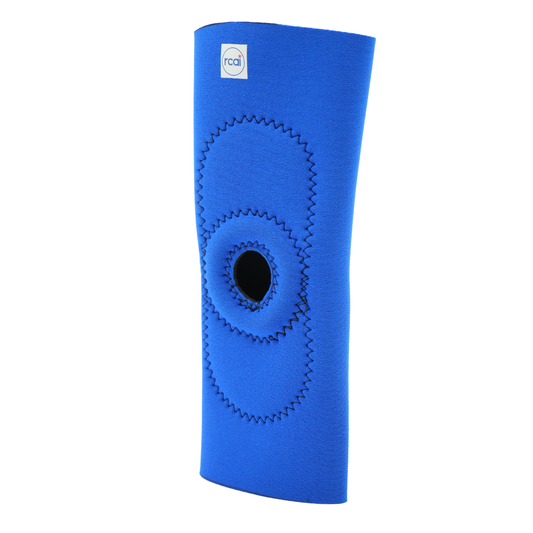 Blue neoprene knee sleeve with central open patella and reinforced zigzag stitching.